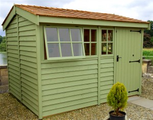 Green wooden garden shed