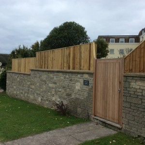 Fencing above stone wall