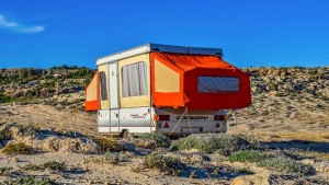 Caravan with red pop out in desert