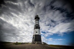 lighthouse under stormy sky