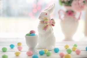 Ceramic easter bunny with chocolate eggs in egg cup