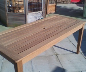 Wooden outdoor dining table with parasol hole 