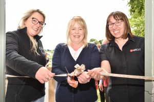 Women cutting ribbon