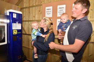 Family buying milk from vending machine