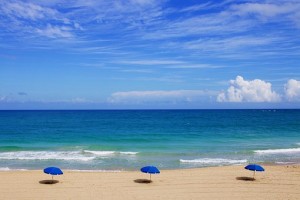 three parasols on sandy beach