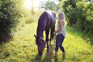 Woman with horse in field