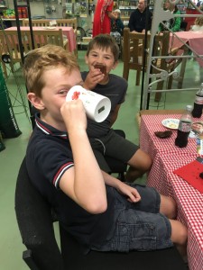 Boys drinking tea on bench