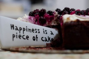 Happiness is a piece of cake slogan on cake