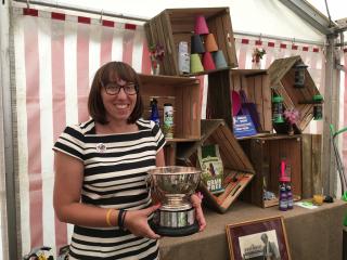 Beth Bright holding winning trade stand trophy