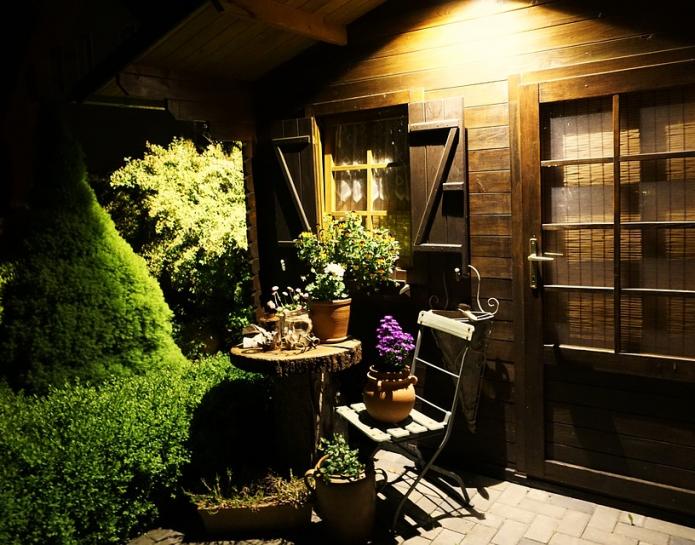 Shed at night with table and chairs outside