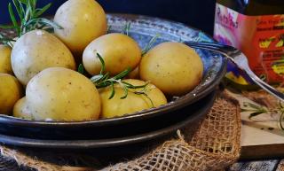 Bowl of new potatoes garnished with rosemary
