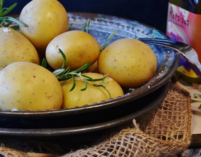 Bowl of new potatoes garnished with rosemary