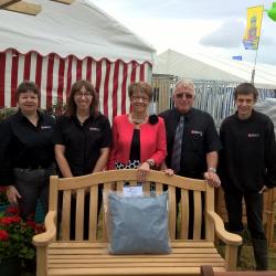 John Bright team behind bench with award